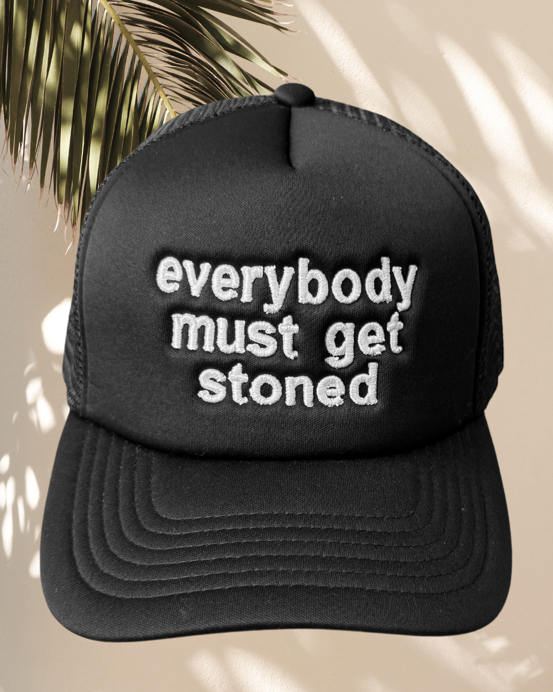 “Everybody Must Get Stoned” Black Trucker Hat
