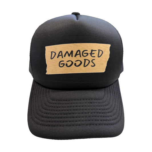 Damaged Goods black trucker hat, front view, by Di Snapback
