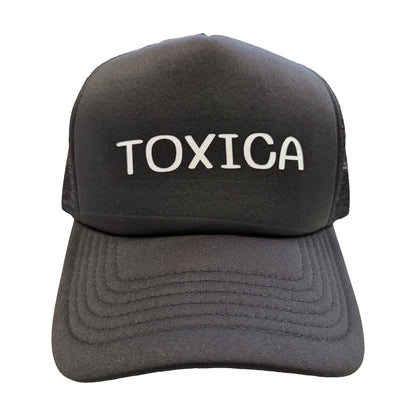Toxica black trucker hat with white lettering, front view, by Di Snapback